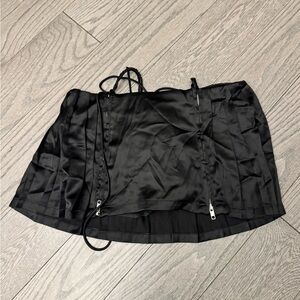 Black pleated mini skirt with zipper detail